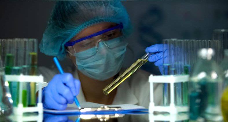 Medical lab worker checking urine sample